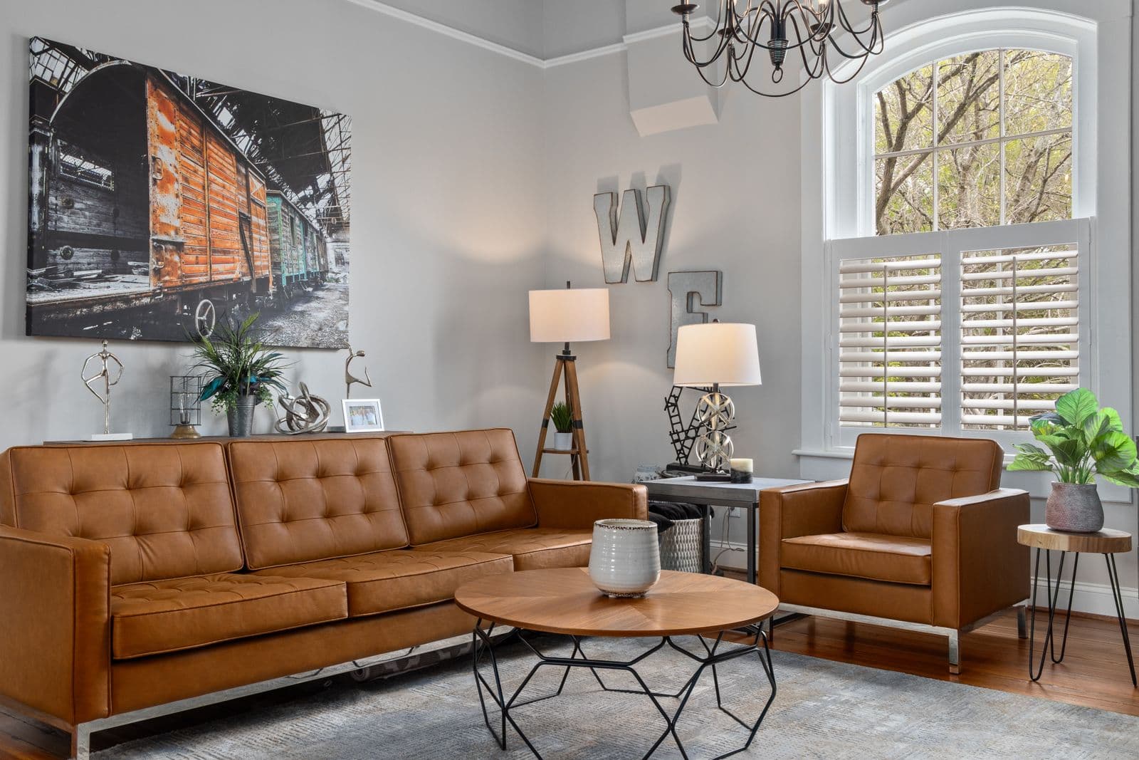 A warm therapy office with tan leather furniture and natural light